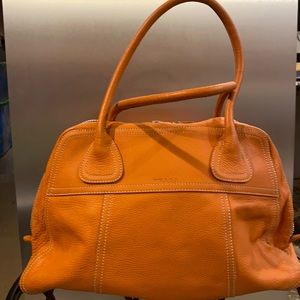 Orange leather Prada purse.